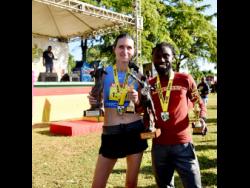 Credit: Ashley Anguin London’s Rosamund Ponder (left) and Jamaica’s Kemar Leslie celebrate winning the respective women’s and men’s half marathon segments in the Reggae Marathon in Negril, Westmoreland, yesterday.