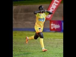 Garvey Maceo’s Rajay McLaughlin celebrates scoring the winning penalty in the daCosta Cup final against McGrath High School. 
