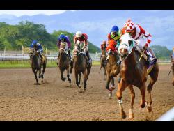 File photo shows FURTHER AND BEYOND (right), ridden by Ian Spencer, winning the Two-Year-Old Stakes at Caymanas Park in 2020.