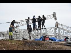 Workmen taking down the light towers at JamWorld Entertainment Complex in Portmore, St Catherine, following the cancellation of Sting 2024.