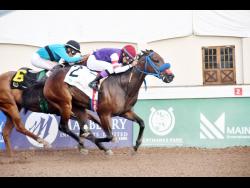 BOOTILICOUS, ridden by Ishmael Velasquez, winning the Christopher ‘Chris’ Armond  Memorial Sprint ahead of DESERT OF MALIBU (Raddesh Roman) over 5 1/2 furlongs at Caymanas Park on Tuesday.