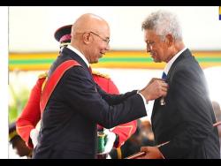 Governor-General , His Excellency the Most Honourable Sir Patrick Allen (left) presents the Order of Distinction (OD) to tennis great Richard Russell in October of 2022.