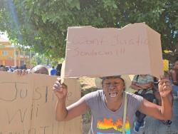 A resident of Fleet Street in Kingston protesting the fatal police shooting of Jermaine Richards on January 23.