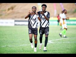 Jalmaro Calvin (left) and Shaquille Stein celebrate Calvin’s goal against Vere Phoenix FC during their Jamaica Premier League football match at Stadium East yesterday. Cavalier won 2-1.
