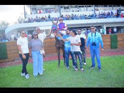 BOOTYLICOUS, with Ismael Velasque in the saddle, parading in the winners’ enclosure with connections after scoring a victory in the Reggae Month Trophy over five furlongs straight at Caymanas Park on Saturday.