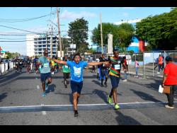 Participants cross the finish line after completing the 5K event.