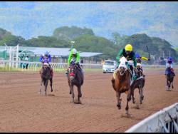  ALLEGIANCE  (right), ridden by Reyan Lewis, wins the seventh race  over a mile at Caymanas Park on Saturday, February 22, 2025.