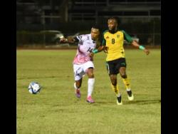 Jamaica’s Demario Phillips (right) and Trinidad & Tobago’s John-Paul Rochford  battle for the ball during an international friendly match held at the Montego Bay Sports Complex on Thursday, February 6, 2025. Jamaica won 1-0.