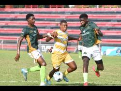 Credit: Ian Allen Molynes United’s Marlon Pennicooke (centre) attempts to go past Vere Phoenix defenders Demoi Kaschief (left) and Robino Gordon during their Wray and Nephew Jamaica Premier League encounter at the Anthony Spaulding Sports Complex on March 5. Molynes won 3-2.