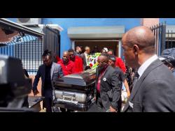 Pallbearers carry the coffin bearing the remains of  Othneil ‘Thickman’ Lobban from Perry’s Hall of Thanksgiving in Spanish Town, St Catherine, yesterday.