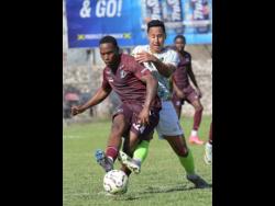Matthew Woo LIng (right) of Vere Phoenix United battles for the ball with Tramain Graham of Chapelton Maroons during a Jamaica Premier League match at the Anthony Spaulding Sports Complex on Sunday, February 16, 2025.