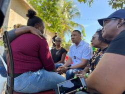 Prime Minister Dr Andrew Holness (centre), Gender Minister Olivia Grange (second right) and State Minister in the Ministry of National Security Juliet Cuthbert-Flynn (second left) console relatives of Kelsey Ferrigon.