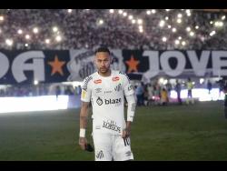 Brazil’s Neymar walks onto the pitch during his debut for Santos FC in a Sao Paulo league soccer match against Botafogo-SP, in Santos, Brazil, on February 5.