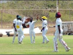 Kensington Cricket Club’s spinner Ryan Francis (centre) is congratulated by teammates after picking up one of his seven wickets against Clarendon CA in their Jamaica Cricket Association Michael Holding Senior Cup semi-final encounter at Jamalco Sports Club on Sunday. 