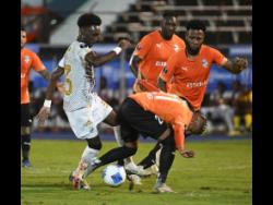 Cavalier’s Shaquile Stein trying to move past Cibao FC players during the Concacaf Caribbean Cup final at the National Stadium on Tuesday, November 26, 2024.