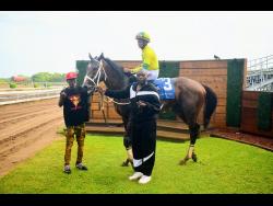 LEGACY ISLES, with Raddesh Roman aboard, parades in the winners’ enclosure after landing the Harlequin Cup  over five furlongs straight at Caymanas Park on Saturday.