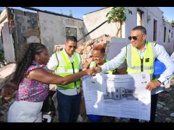 Prime Minister Dr Andrew Holness (right), greets architect of the East Palms Housing Development in Kingston Central, Roni McLaren (left), during Wednesday’s ground-breaking ceremony on East Avenue in the constituency. Member of Parliament, Kingston Central, Donovan Williams (second left), and project beneficiary, representing the Palmer family, Doreen Palmer, look on. The new development will replace the previous dwelling, which was destroyed by fire in July 2021, leaving a 13-member family homeless. 