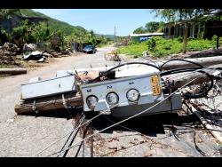 Jamaica Public Service utility poles lie toppled along Guts River Road in Alligator Pond, Manchester, following the passage of Hurricane Beryl last July.