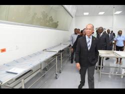 Deputy Prime Minister and Minister of National Security Dr Horace Chang tours the Forensic Pathology Autopsy Suite in Kingston. 