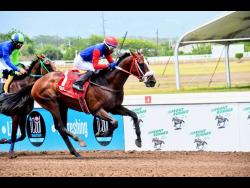 TITAN TEMPO, ridden by Reyan Lewis, winning the second race over 7 1/2 furlongs  at Caymanas Park on Sunday.