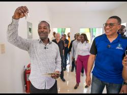 Prime Minister Dr Andrew Holness (right) shares a joyful moment with Patrick Sawyers, the newest recipient of a two-bedroom home under the Government’s New Social Housing Programme.