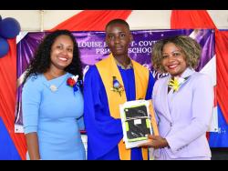 Minister of Education, Skills, Youth and Information, Senator Dr Dana Morris Dixon (right), presents a tablet to Chadrick Bailey (centre), the most improved student at Louise Bennett-Coverley Primary School, at the recent graduation ceremony held at the school campus in Gordon Town, St Andrew. Sharing the moment is Sheena Taylor Morgan, the school principal.