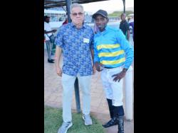 Veteran trainer Philip Feanny (left) and jockey Phillip Parchment stand side by side after combining to deliver RHYTHM BUZZ as the winner of the Liu Chie PooTrophy, over nine furlongs, at Caymanas Park on Saturday, June 14.
