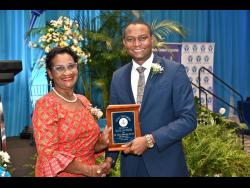 Credit: Rudolph Brown Dr Mark Smith, president of the Jamaica Teachers’ Association, presents an award to Dr Glenda Prescod for 49 years of service to teaching.