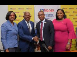 Minister of Labour and Social Security, Pearnel Charles Jr (second left), shares a symbolic handshake with General Manager of JN Money Services, Horace Hines, during Wednesday’s launch of the Jamaica National (JN) Fields of Opportunity Scholarships, held at the JN Financial Centre on Belmont Road in New Kingston. Sharing the moment are (from left) Acting Permanent Secretary in the ministry, Dionne Jennings; and Assistant General Manager of JN Money Services, Sanya Wallace.