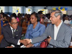 Credit: Contributed State Minister in the Ministry of Labour and Social Security, Dr Norman Dunn (left), greets UNICEF Deputy Country Representative, Mohammad Mohiuddin, at the Early Stimulation Programme graduation ceremony, held at the Apostolic Church of Jamaica, Bethel Temple, in downtown Kingston on Wednesday. Looking on is Acting Permanent Secretary in the ministry, Dione Jennings.