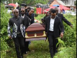 Pallbearers carry the body of Vincent Morgan to the Commodore Cemetery yesterday after the thanksgiving service.
