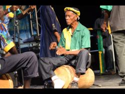 With the steady beat of the drum echoing through the night, a drummer from the Port Morant Kumina Group performs at Emancipation Jubilee in 2018.