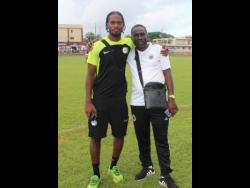 Anthony Baker Jr (left), organiser of the Clarendon Elite Football competition, with his father Anthony Sr at the end of the competition on Sunday at the Glenmuir High School field.