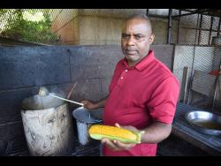 Peanut porridge and corn soup vendor Oral Powell has one of the most visited food spots in Manchester, along the Spur Tree main road.