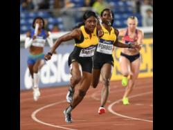 Jonielle Smith (left) receives the baton from Shashalee Forbes in the women’s 4x100-metre relay heats at the 2021  IAAF World Relays in Yokohama, Japan.
