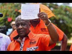PNP candidate for Central Manchester Donovan Mitchell shows off his nomination receipt.
