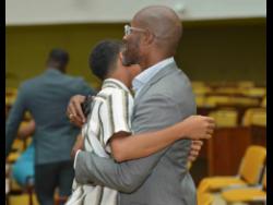 Young scholar Daniel* gets a hug from his dad at the recent Child Protection and Family Service Agency’s PEP Awards Ceremony, held at the Jamaica Conference Centre in downtown Kingston.