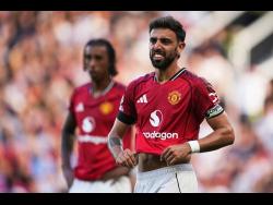 Manchester United’s Bruno Fernandes grimaces after missing a penalty.