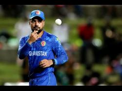 Afghanistan’s captain Rashid Khan throws the ball to a teammate during a Men’s T20 World Cup cricket match against South Africa at Brian Lara Cricket Academy in Tarouba, Trinidad & Tobago, on Wednesday, June 26, 2024.