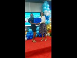 Dijuana Jackson (left) collecting award for Top Girl at the Petrojam PEP scholars award ceremony held recently.