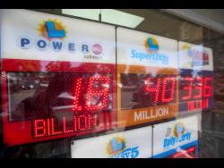 An electronic sign reads $1.8 billion as crowds wait in line to buy lottery tickets at the Bluebird Liquor store in Hawthorne, California, on Friday, September 5, 2025. 