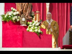 Relics of Carlo Acutis and Pier Giorgio Frassati (left) are displayed during their canonisation Mass celebrated by Pope Leo XIV in St. Peter’s Square at the Vatican yesterday.