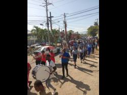 Students of Linstead Primary School take part in the anniversary march on Monday.