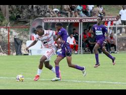 Orane Watson (left) of Glenmuir High and Bustamante’s Omario Brissettt tussle for the ball during their ISSA/WATA daCasta Cup football match at Glenmuir yesterday. Watson scored eight goals.