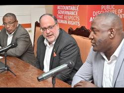 PNP President Mark Golding, (centre), the party’s General Secretary Dayton Campbell, (right), and Anthony Hylton, legal adviser at a press conference on Thursday at the party headquarters on Old Hope Road in St Andrew. 