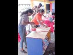  Super Valu Home Centre’s Bellina Tarty (left) and Maline Leyow (right) try their hands at applying Berger’s Alkali Sealer during the company’s contractor academy workshop. 