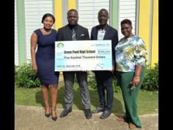 From left: Tameka Bryce, vice-chairman of the Green Pond High’s board of management, Oraine Ebanks, principal of Green Pond High, Omar McFarlane, businessman, and Lornette Myrie, vice-principal of Green Pond High, during a cheque presentation at Green Pond High on Monday, September 22. McFarlane donated $500,000 towards the school’s football programme.