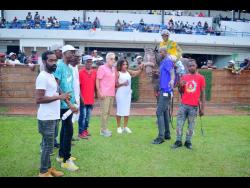 RIDEALLDAY, with veteran jockey Ian Spence in the saddle, stand in the winners’ enclosure with connections after winning the sixth race over 5 1/2 furlongs at Caymanas Park on Saturday.