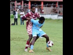 Credit: Ashley Anguin Maldon High’s Clevon Campbell (front) shields the ball from Herbert Morrison Technical High’s Demetri Popkin during their Zone A ISSA daCosta Cup football match at the Herbert Morrison High on Tuesday.