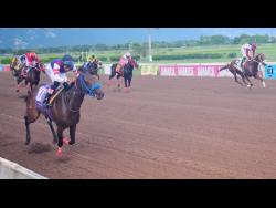 BOOTYLICIOUS (left), ridden by Raddesh Roman, winning Division One of the Nigel Nunes Memorial Cup ahead of PRINCE AMANN (right, Robert Halledeen) at Caymanas Park yesterday.